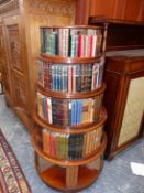 A 19th.C. MAHOGANY REVOLVING BOOK CASE WITH SOME BOOKS, EACH OF THE FIVE GRADUATED CIRCULAR TIERS