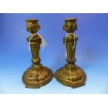 A PAIR OF GILT BRONZE CANDLESTICKS CAST IN THE HUGUENOT TASTE, EACH FOOT WITH THREE FOLIATE STRAPS