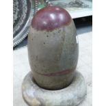 AN INDIAN RIVER POLISHED LINGAM STONE, THE OLIVE GREEN STONE WITH A LIVER RED CAP AND MARKINGS.