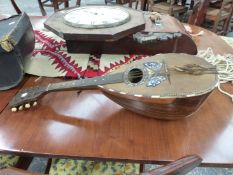 A LEATHERETTE CASED STRIDENTE OF NAPOLI MANDOLIN, THE SOUNDBOARD INLAID WITH A BUTTERFLY .