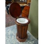 A VICTORIAN MAHOGANY CYLINDER FORM LIFT TOP BEDSIDE CABINET, WITH WASH BASIN. Dia.42 x H.78cms.