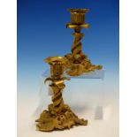 A PAIR OF ROCOCO BRONZE CANDLESTICKS, THE NOZZLES SUPPORTED ON THREE INTERTWINED DOLPHINS, EACH OF