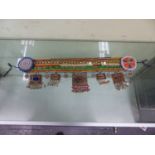 AN ISLAMIC BEADED TEXTILE BELT SEWN WITH 1990S TURKISH COINS AND HUNG WITH COLOURED PASTE MOUNTED