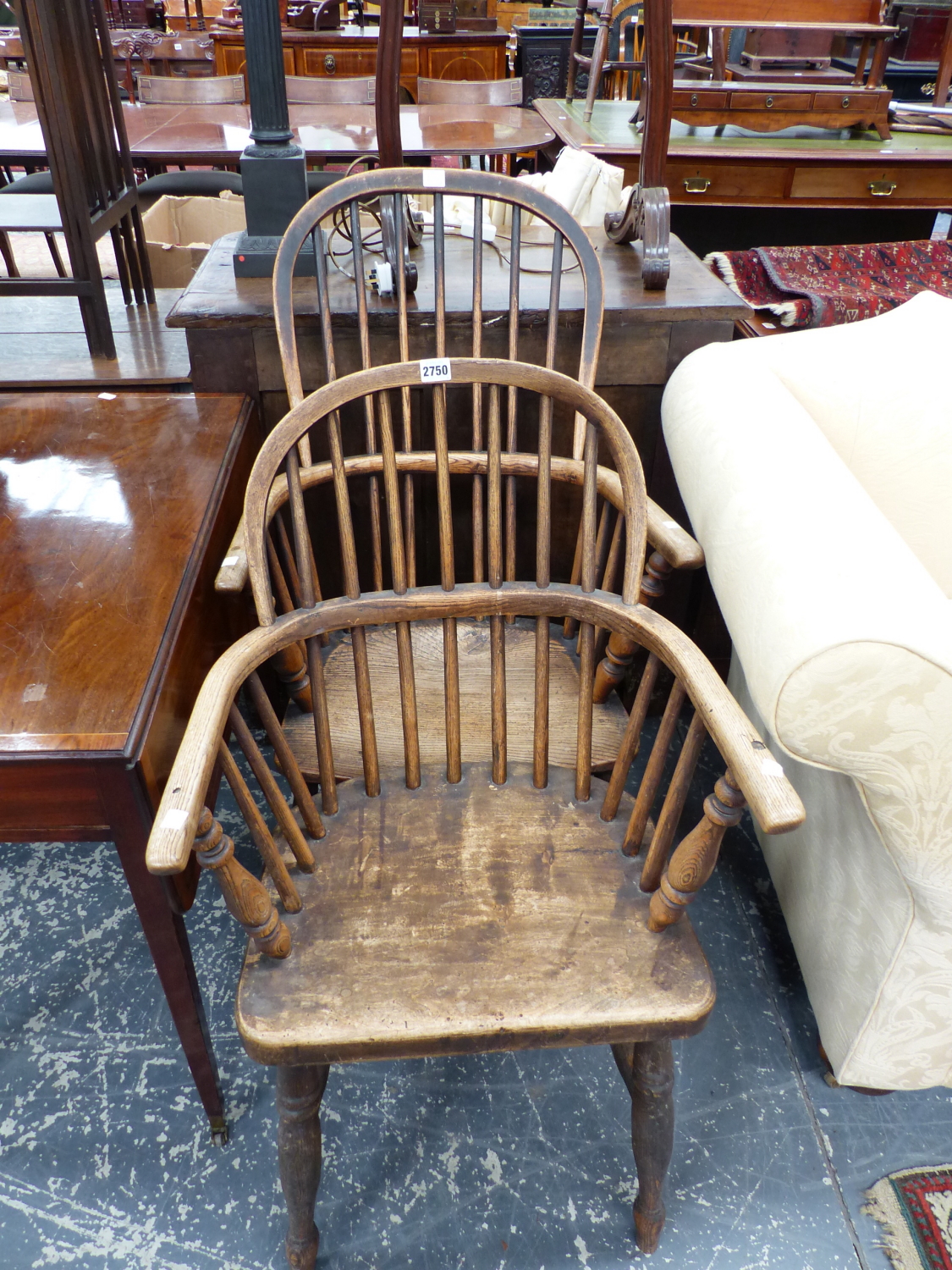 TWO OAK AND ELM WINDSOR CHAIRS WITH ROUND ARCH HOOPS SUPPORTING THE STICK BACKS AND FORMING THE ARMS