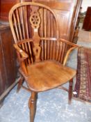 A 19th.C. YEW WOOD AND ELM WHEEL BACK WINDSOR ARMCHAIR WITH CRINOLINE STRETCHER.