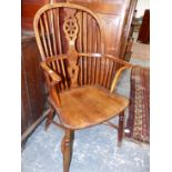 A 19th.C. YEW WOOD AND ELM WHEEL BACK WINDSOR ARMCHAIR WITH CRINOLINE STRETCHER.