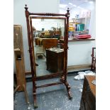 A REGENCY MAHOGANY CHEVAL MIRROR ON TURNED COLUMN SUPPORTS AND SABRE LEGS 84 CM WIDE X 178 CM HIGH.