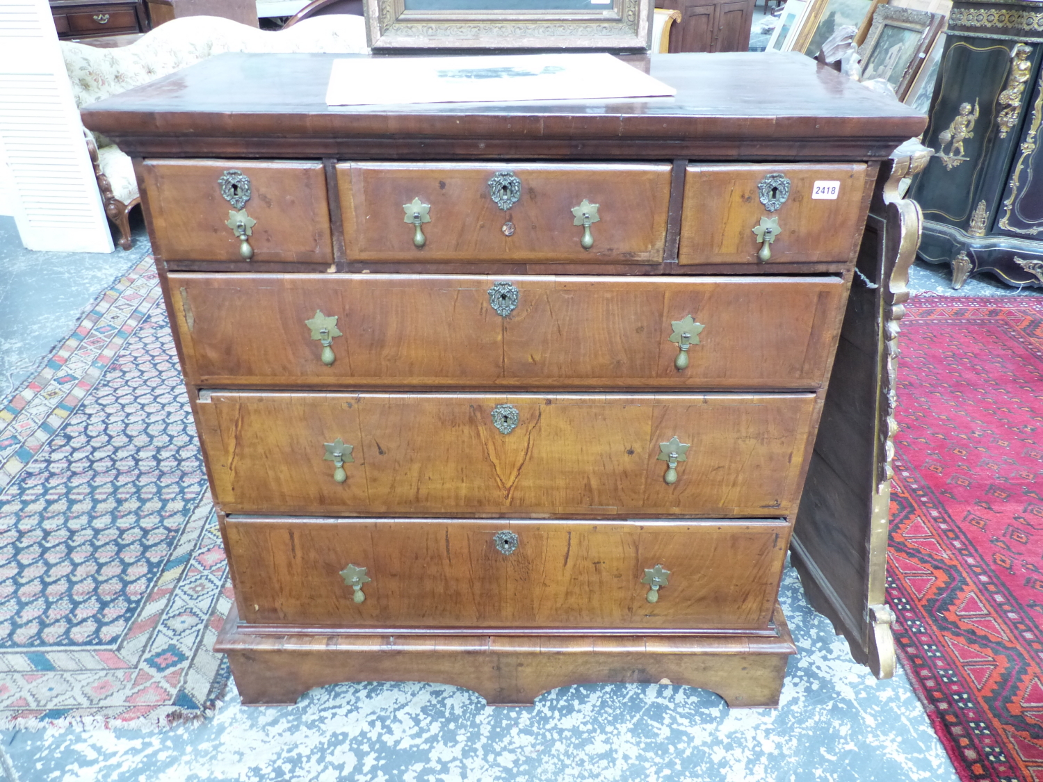 AN 18th.C. AND LATER WALNUT CHEST OF THREE SHORT AND THREE LONG GRADUATED DRAWERS ON SHAPED PLINTH
