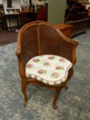 A LOUIS XV STYLE CARVED BERGERE TUB FORM DESK CHAIR, SQUAB CUSHION.