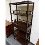 A PADOUK WOOD OPEN BOOK CASE WITH FOUR GALLERIED SHELVES ABOUT TWO CENTRAL DRAWERS. W 76.5 x D 35