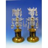 A PAIR OF TWO TIER LUSTRE CUT GLASS CANDLESTICKS ON CYLINDRICAL BLUE PORCELAIN BASES GILT WITH