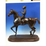 AFTER CHARLES VALTON, A BRONZE FIGURE OF A JOCKEY RIDING A STALLION. H 58cms.