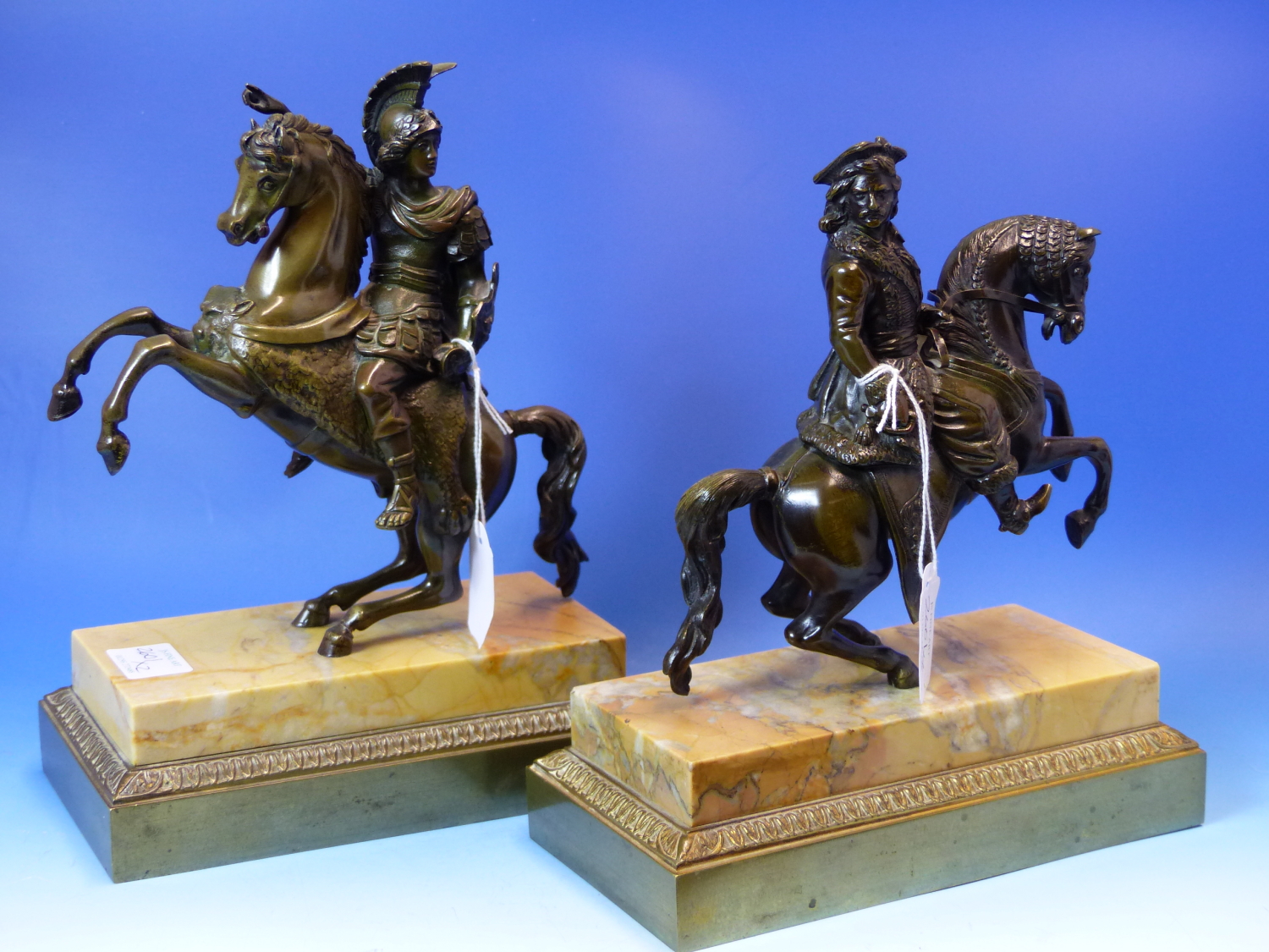 A PAIR OF 19th.CENTURY EQUESTRIAN BRONZES OF A COSSACK AND A ROMAN SOLDIER, THEIR HORSES REARING ON