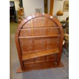 AN ARTS AND CRAFTS ACORN MAN OAK PANEL BACK ARCHED TOP BOOKCASE WITH ADZE FINISH. W.93 x D.17 x H.