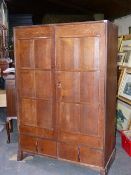 ATTB. PETER WAALS (1870-1937) AN ARTS AND CRAFTS HAND MADE OAK CUPBOARD/ WARDROBE WITH SHAPED