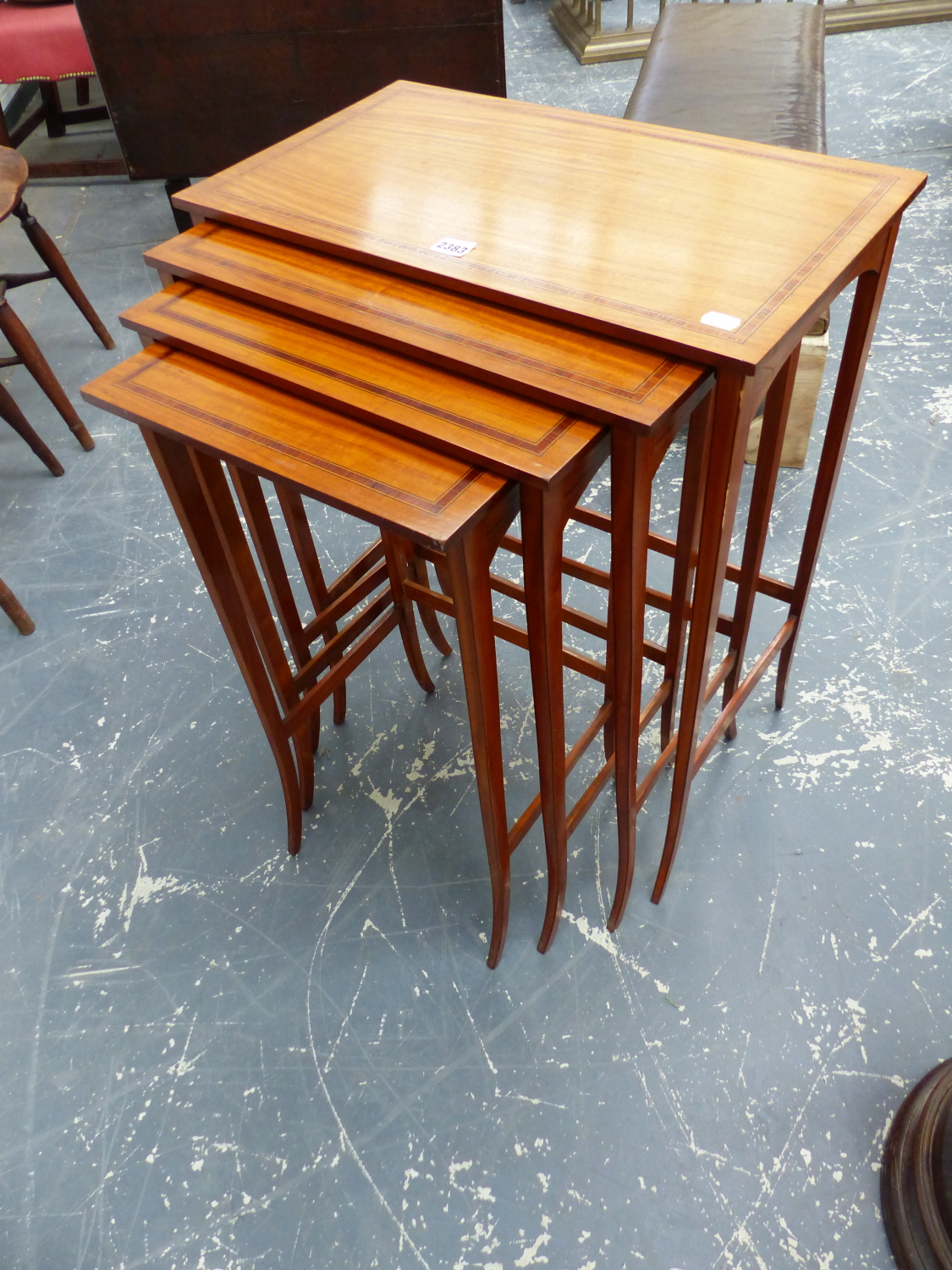 AN EDWARDIAN INLAID SATINWOOD NEST OF FOUR TABLES, TAPERED LEGS.