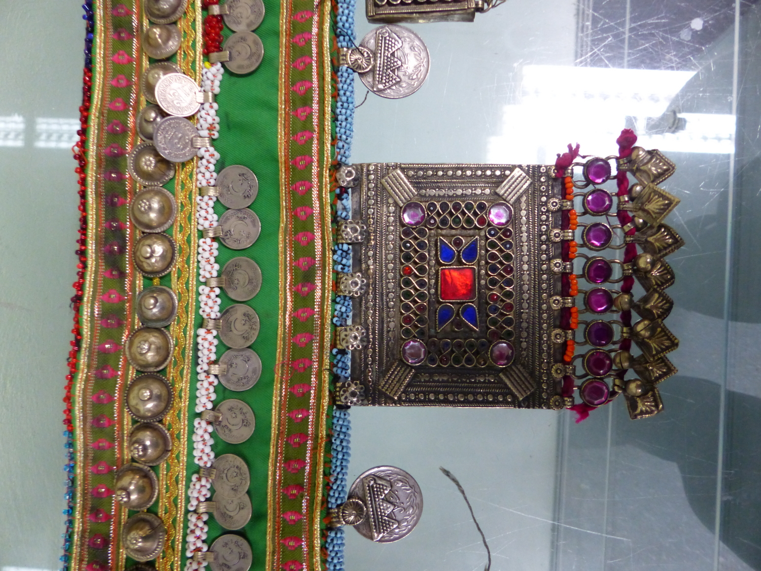 AN ISLAMIC BEADED TEXTILE BELT SEWN WITH 1990S TURKISH COINS AND HUNG WITH COLOURED PASTE MOUNTED - Image 2 of 7