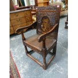 AN ANTIQUE.COUNTRY OAK WAINSCOT CHAIR WITH CARVED PANEL BACK.