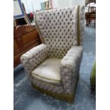 AN UNUSUAL BUTTON SILK UPHOLSTERED WING BACK ARMCHAIR.