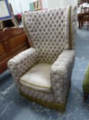 AN UNUSUAL BUTTON SILK UPHOLSTERED WING BACK ARMCHAIR.