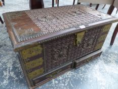 A CARVED TEAK AND BRASS MOUNTED ZANZIBAR TYPE CHEST. W.74 x D.41 x H.41cms.