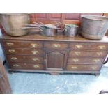 AN 18th.C.OAK AND CROSSBANDED DRESSER WITH ARRANGEMENT OF NINE DRAWERS AND CENTRAL PANEL DOOR