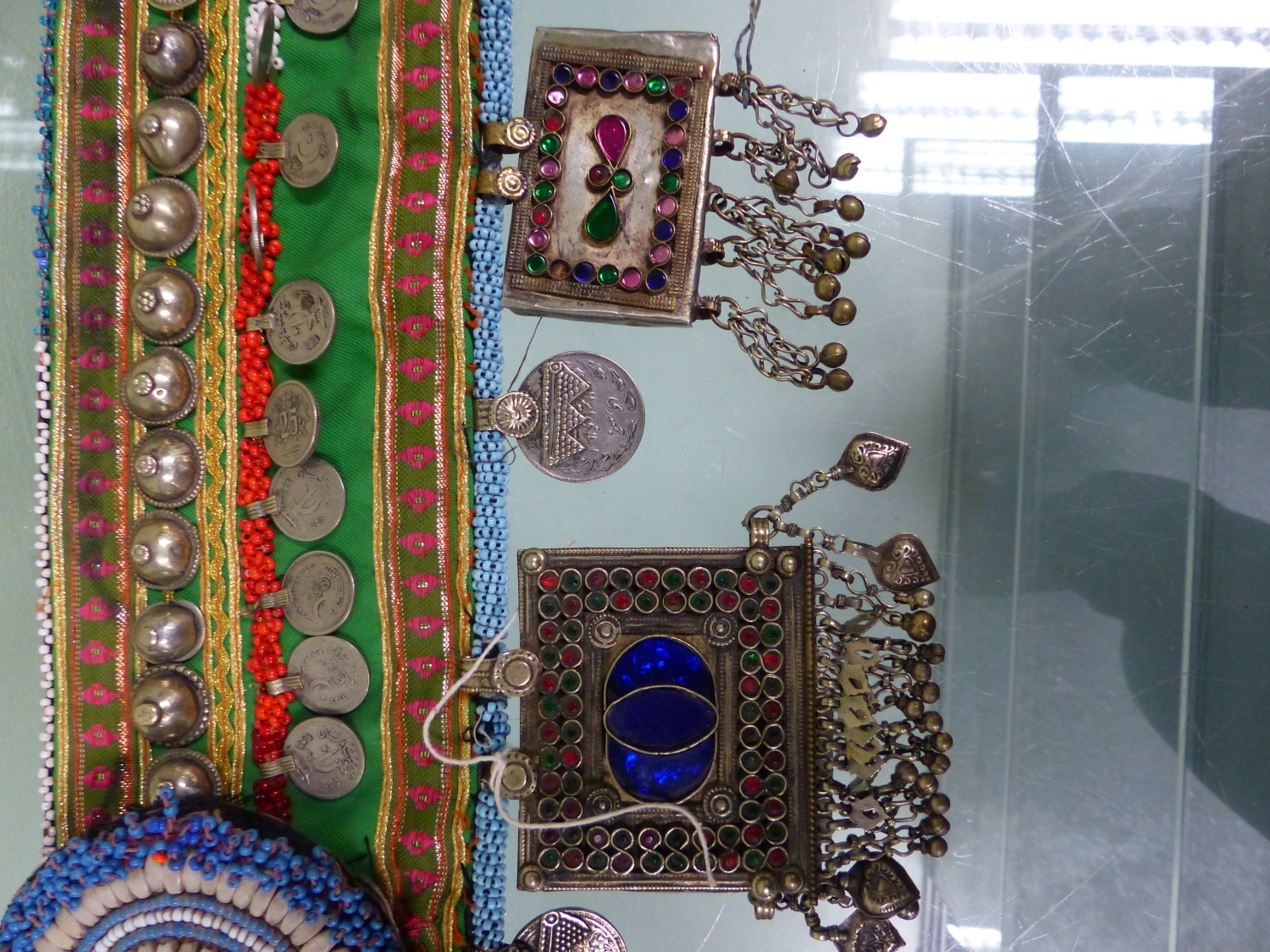 AN ISLAMIC BEADED TEXTILE BELT SEWN WITH 1990S TURKISH COINS AND HUNG WITH COLOURED PASTE MOUNTED - Image 4 of 7