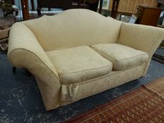 AN ANTIQUE TWO SEAT SETTEE WITH SHAPED BACK AND SPLAY ARMS. W.200cms.