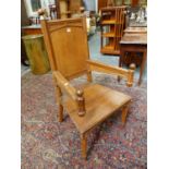 AN UNUSUAL VICTORIAN GOTHIC OAK ARMCHAIR ON OCTAGONAL TAPERED LEGS.