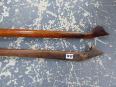 TWO EASTERN WOODEN YOKES WITH CARVED ENDS FORMING STOPS FOR THE LIKE OF BUCKET HANDLES. W 131cms.