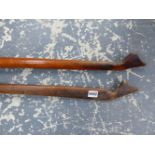 TWO EASTERN WOODEN YOKES WITH CARVED ENDS FORMING STOPS FOR THE LIKE OF BUCKET HANDLES. W 131cms.