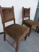 A PAIR OF VICTORIAN GOTHIC REVIVAL HALL CHAIRS WITH CARVED FORELEGS AND STRETCHERS.