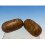 TWO INDIAN RIVER POLISHED OCHRE BRECCIATED GREEN LINGAM STONES. W 6.5cms.