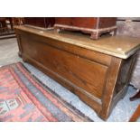 AN UNUSUAL STAINED BEECHWOOD COFFER WITH PANEL FRONT AND SIDES. W.132 x D.38 x H.48cms.