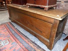 AN UNUSUAL STAINED BEECHWOOD COFFER WITH PANEL FRONT AND SIDES. W.132 x D.38 x H.48cms.