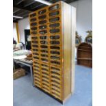 A GOOD LARGE MID CENTURY HABERDASHERY CABINET CONSISTING OF FIFTY FOUR DRAWERS WITH GLAZED FRONTS.
