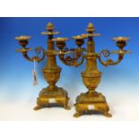 A PAIR OF ORMOLU TWO BRANCH CANDLEABRA, THE ARMS SCROLLING EITHER SIDES OF CENTRAL VASES ON SQUARE