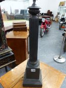 A BRONZE FLUTED COLUMN TABLE LAMP CAST WITH A BAND OF LEAVES ABOVE THE SQUARE FOOT. H 63cms.