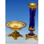 A FLORAL ENAMELLED ROYAL BLUE GROUND WAISTED CYLINDRICAL VASE ON FOUR ORMOLU FEET. H 15cms. ROGETHER