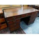 A GEORGIAN OAK TWIN PEDESTAL PARTNERS DESK WITH PLAIN OAK TOP OVER FRIEZE DRAWERS AND SIX DRAWERS TO