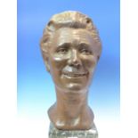 LOUISA BOLT, 1971, A BRONZE HEAD OF A SMILING LADY, ON GREEN MARBLE PLINTH. H 48.5cms.