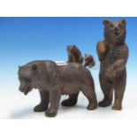 FOUR VARIOUS BLACK FOREST CARVED WOODEN BEARS, THE TALLEST STANDING ERECT. H 27cms.