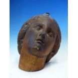 A CARVED PINE HEAD OF A FEMALE SAINT LOOKING HEAVENWARDS. H 26cms.