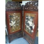 AN ORIENTAL TWO FOLD SCREEN WITH IVORY CARVED RELIEF PANELS OF BIRDS. OVERALL SIZE 154 x 183cms.