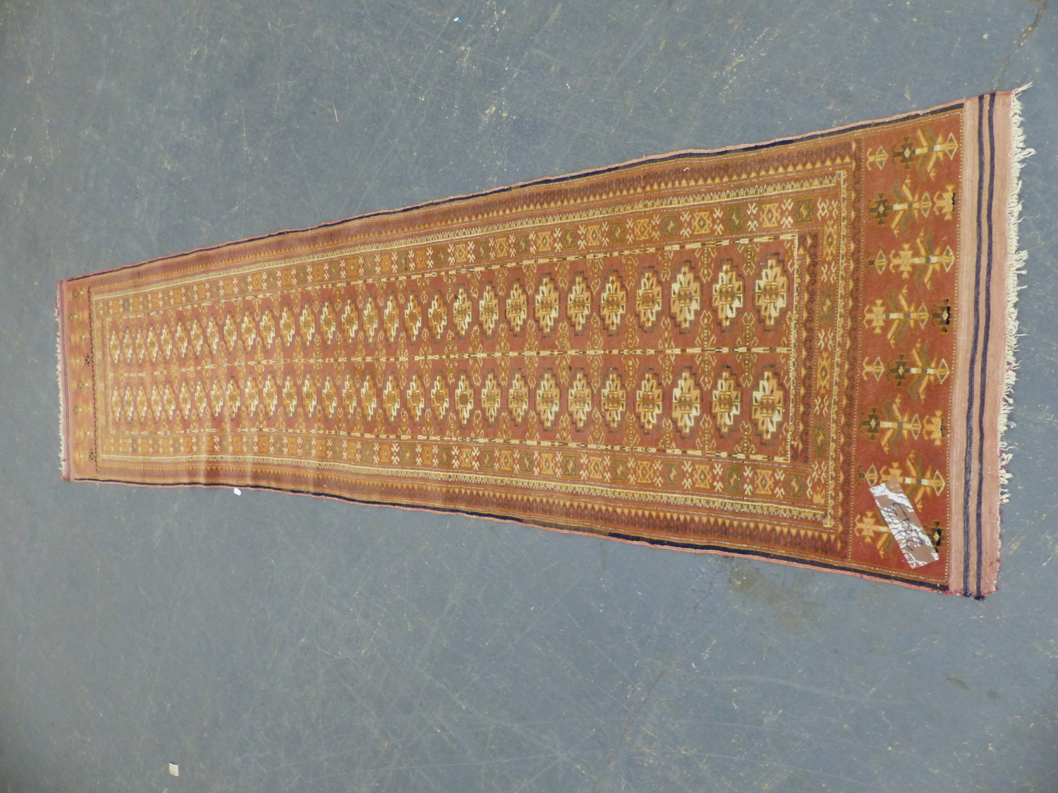 A TEKKE BOKHARA RUNNER. 306 x 75cms.