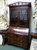 A LATE GEORGIAN MAHOGANY BUREAU BOOKCASE WITH PIERCED CORNICE OVER GLAZED DOORS, THE FALL WITH