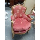 A LOUIS XV STYLE GREY PAINTED FAUTEUIL UPHOLSTERED IN PINK DAMASK.