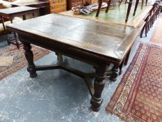 A 17th.C.STYLE OAK DRAW LEAF REFECTORY DINING TABLE ON TURNED SUPPORTS WITH WIDE FORM STRETCHER. L.