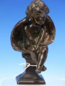 A 19th C. BRONZE FIGURE OF A SEATED CUPID, HIS WINGS WRAPPED BEHIND HIM LIKE A BILLOWING CLOAK, HE