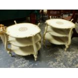 A PAIR OF CREAM AND GILT DECORATED ITALIANATE THREE TIER LAMP TABLES.
